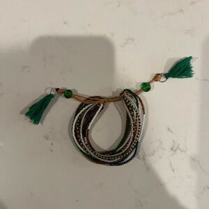 Handmade beaded multi strand bracelet with tassels. Not adjustable.